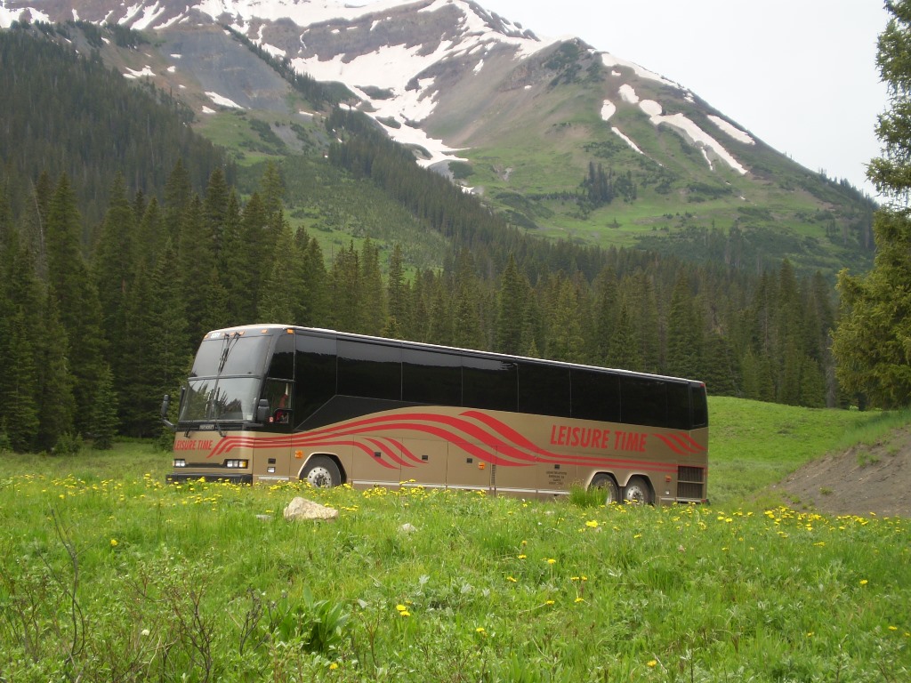 Bus in Colorado with snowy mountains in background